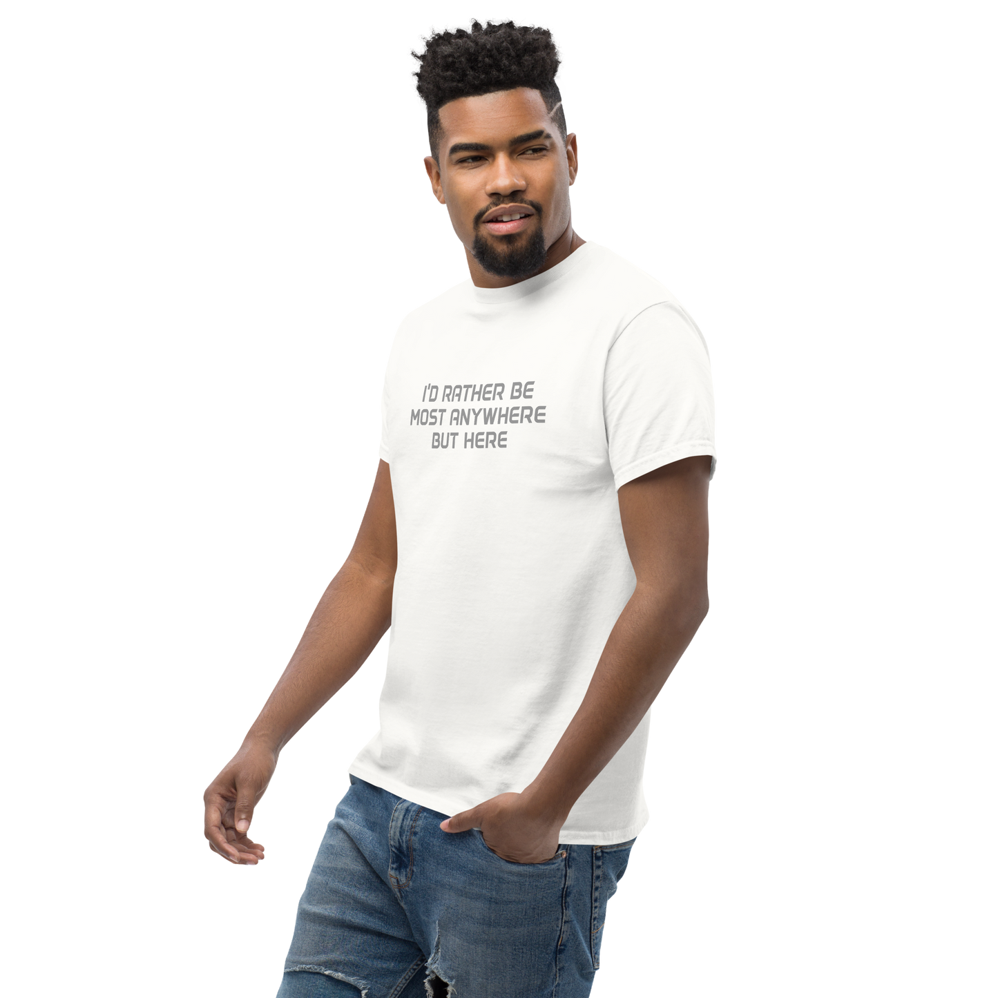 "I’d rather be most anywhere but here" printed on a white unisex classic tee worn by a male