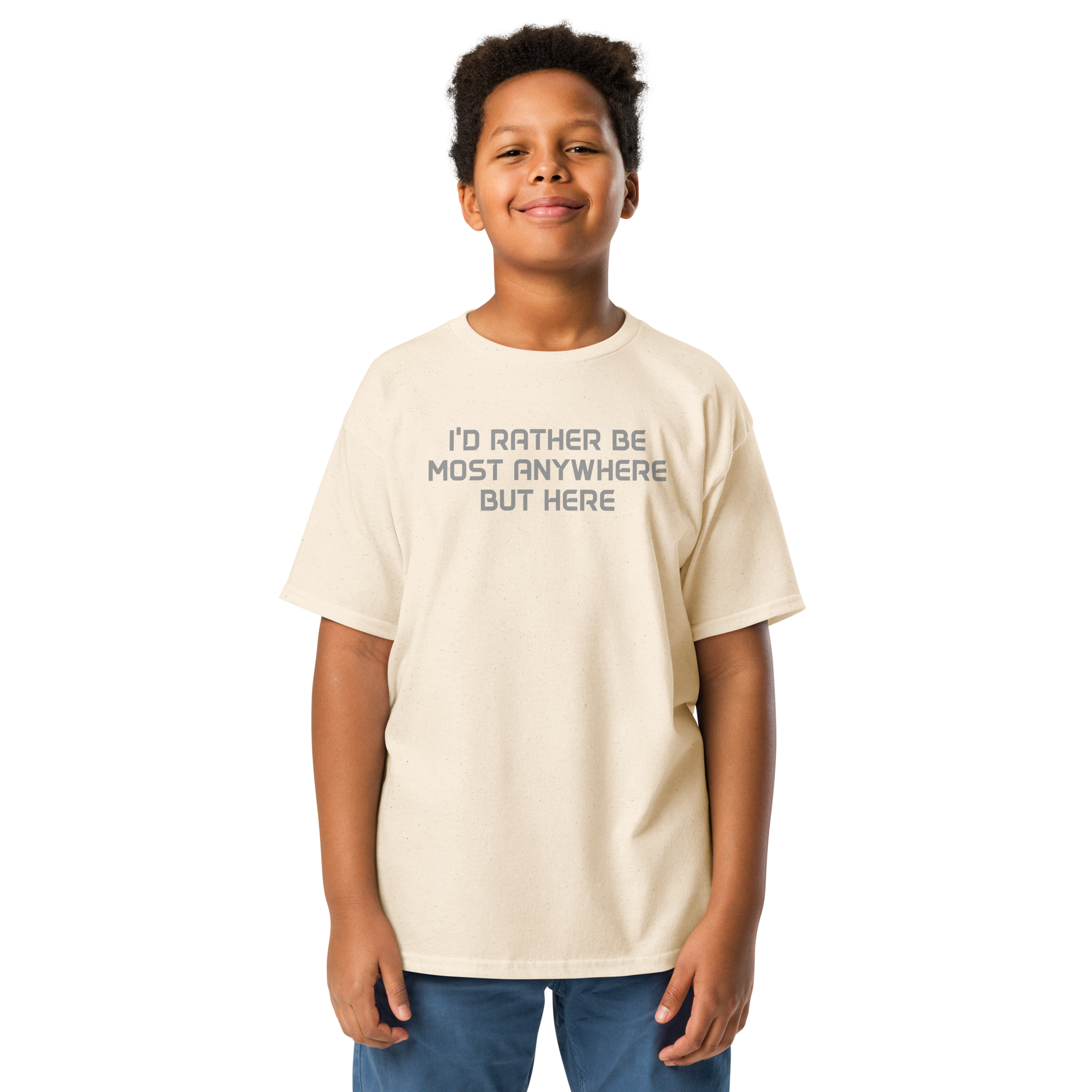"I’d rather be most anywhere but here" printed on a natural youth classic tee worn by a male