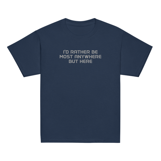 "I’d rather be most anywhere but here" printed on a navy youth classic tee laying on a flat surface