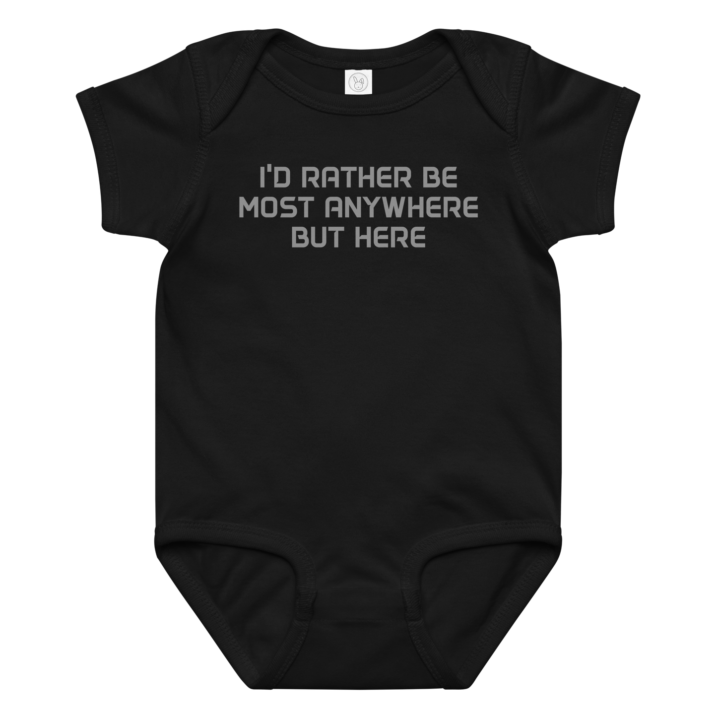 "I’d rather be most anywhere but here" printed on a black baby jersey bodysuit laying on a flat surface amongst other clothes