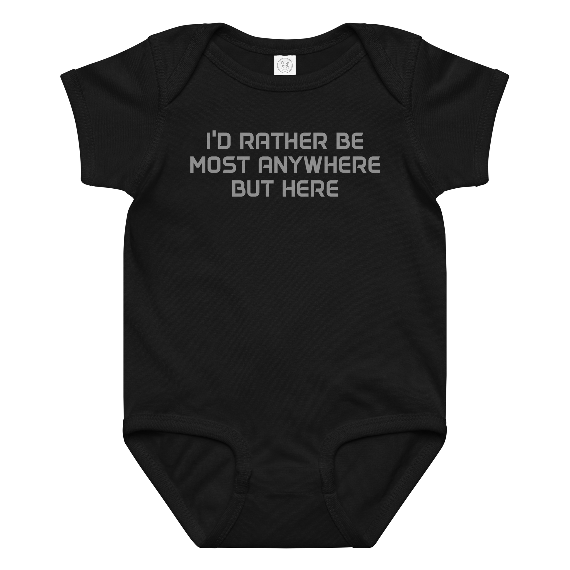 "I’d rather be most anywhere but here" printed on a black baby jersey bodysuit laying on a flat surface amongst other clothes