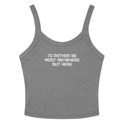 "I’d rather be most anywhere but here" printed on a athletic heather women's micro-rib tanktop laying on a flat surface amongst sunglasses and shorts
