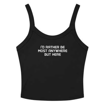 "I’d rather be most anywhere but here" printed on a solid black blend women's micro-rib tanktop laying on a flat surface amongst sunglasses and shorts
