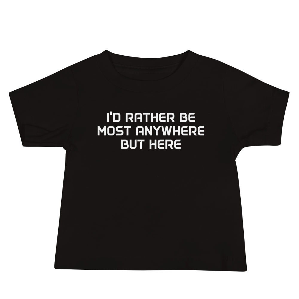"I’d rather be most anywhere but here" printed on a black baby jersey short sleeve tee laying on a flat surface