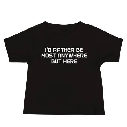 "I’d rather be most anywhere but here" printed on a black baby jersey short sleeve tee laying on a flat surface
