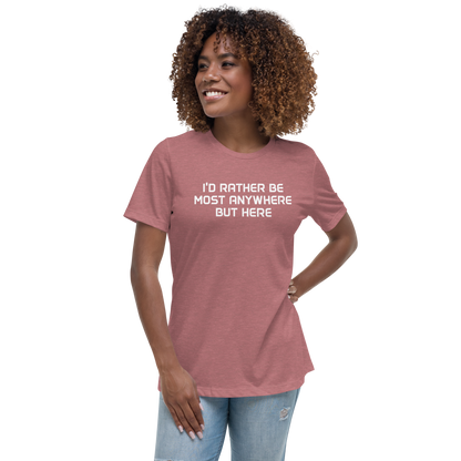 "I’d rather be most anywhere but here" printed on a heather mauve women's relaxed t-shirt worn by a female