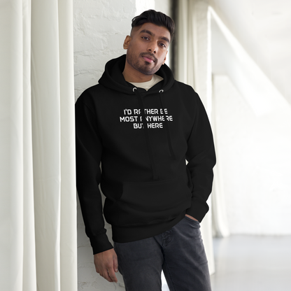 "I’d rather be most anywhere but here" printed on a black unisex hoodie worn by a male