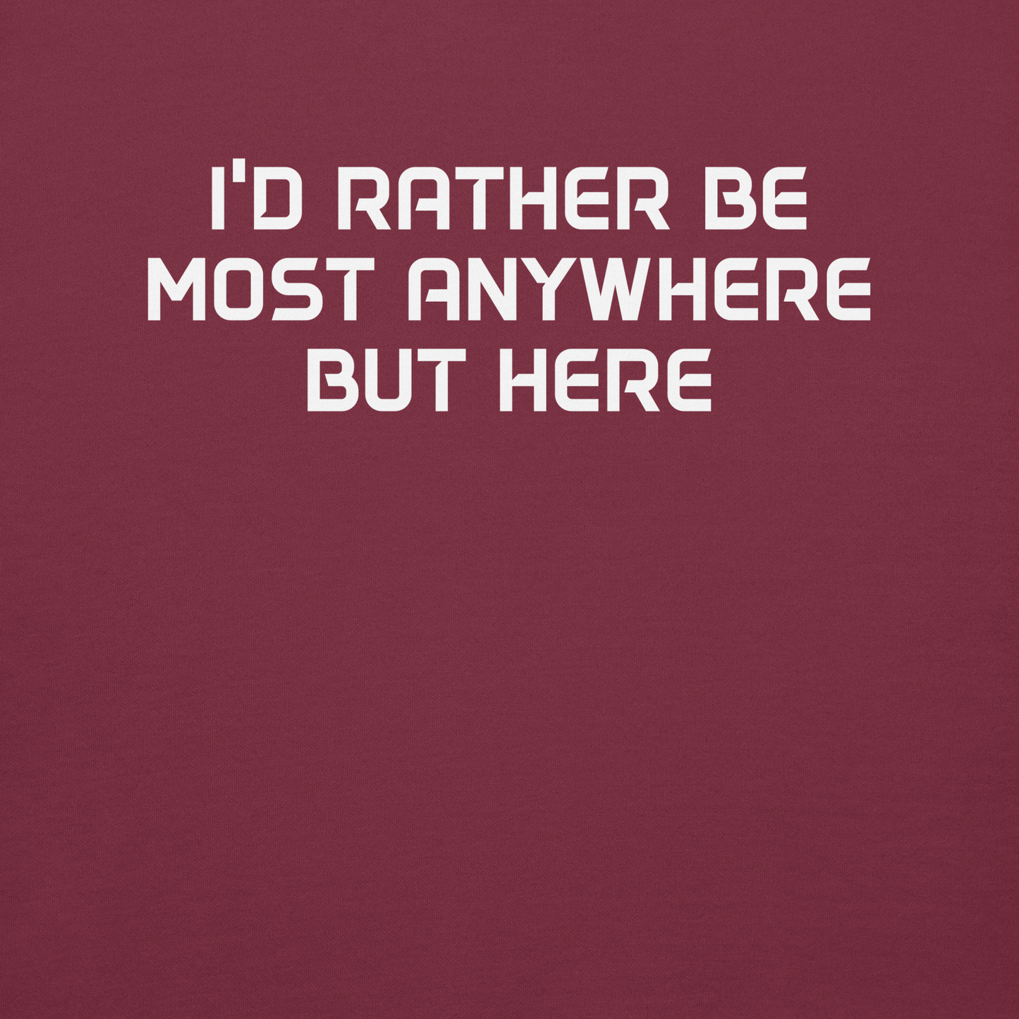 "I’d rather be most anywhere but here" printed on a maroon background
