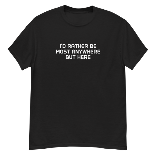 "I’d rather be most anywhere but here" printed on a black unisex classic tee laying on a flat surface
