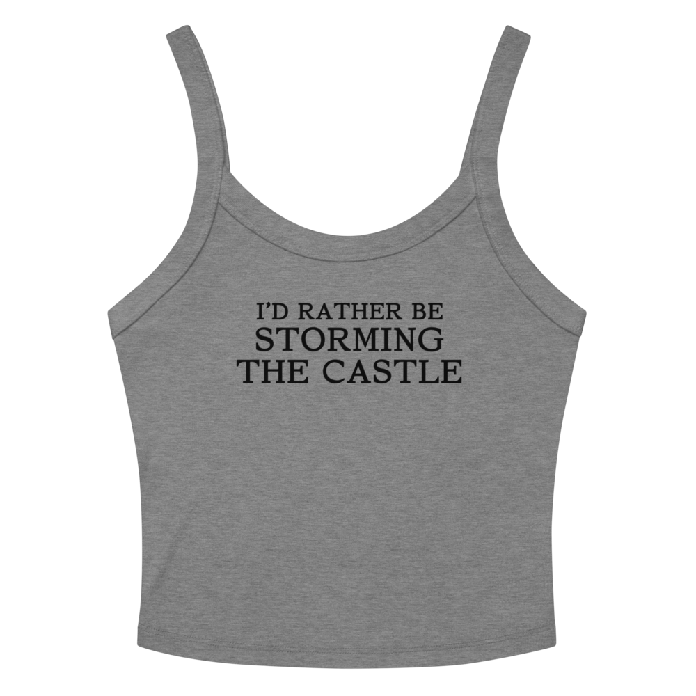 "I'd rather be storming the castle" printed on a athletic heather women's micro-rib tanktop laying on a flat surface amongst sunglasses and shorts
