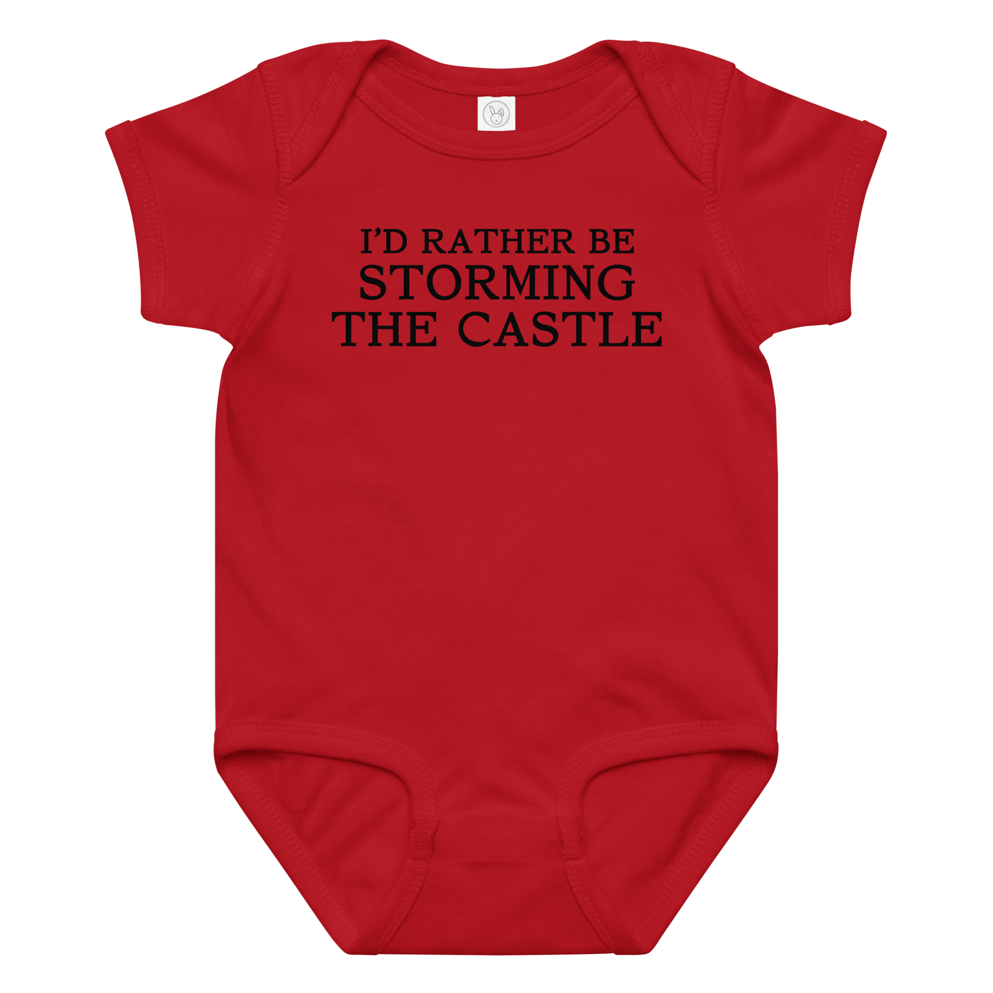 "I'd rather be storming the castle" printed on a red baby jersey bodysuit laying on a flat surface amongst other clothes