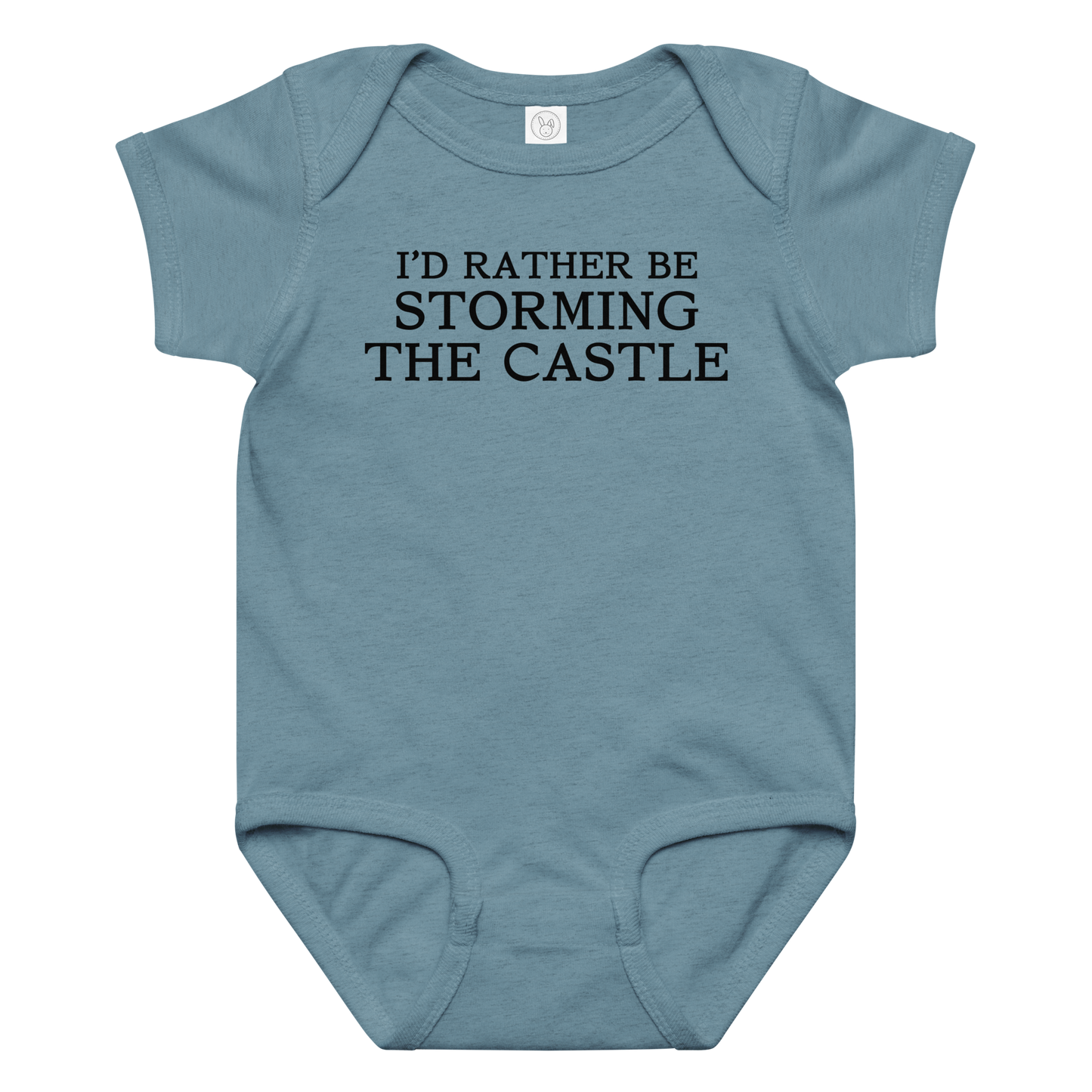 "I'd rather be storming the castle" printed on a vintage indigo baby jersey bodysuit laying on a flat surface amongst other clothes