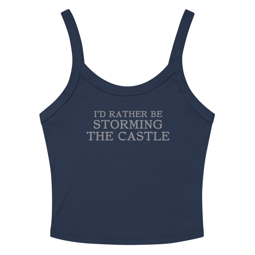 "I'd rather be storming the castle" printed on a solid navy blend women's micro-rib tanktop laying on a flat surface amongst sunglasses and shorts