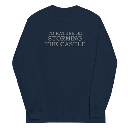 "I'd rather be storming the castle" printed on a navy men's long sleeve shirt laying on a flat surface