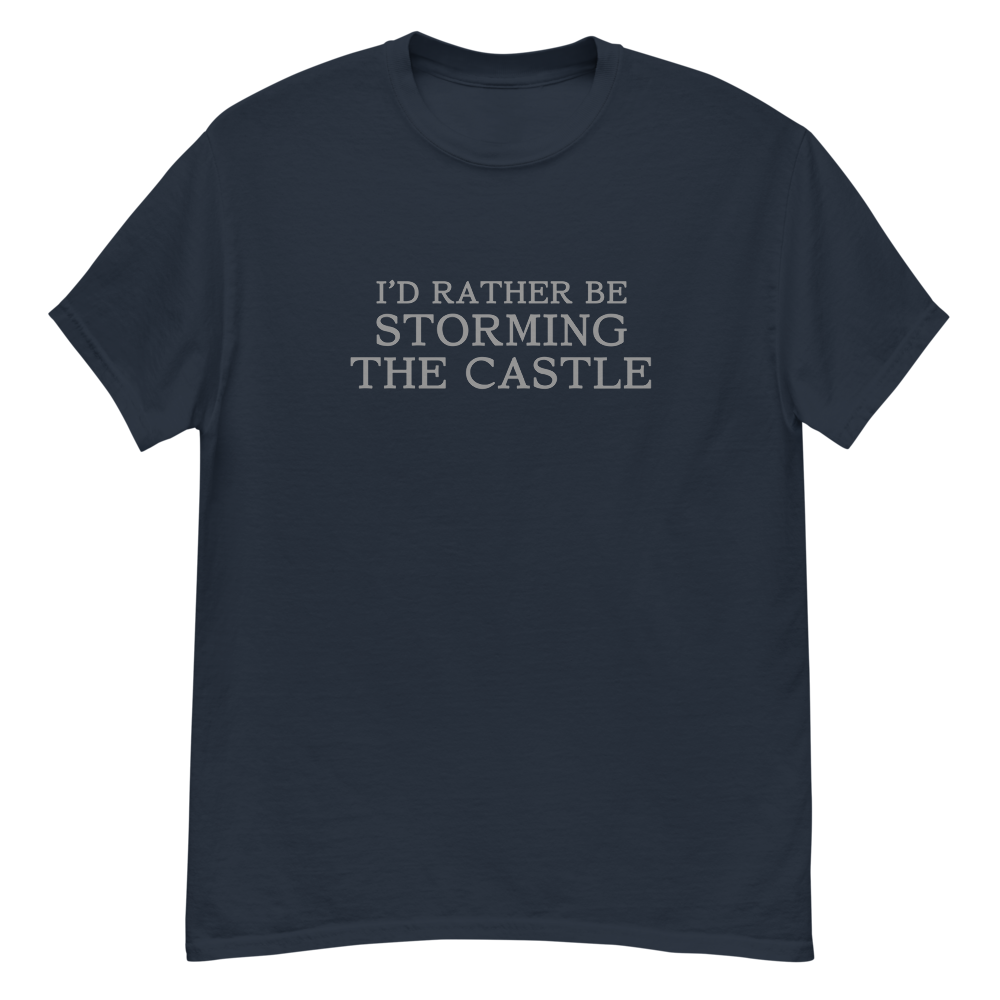 "I'd rather be storming the castle" printed on a navy unisex classic tee laying on a flat surface