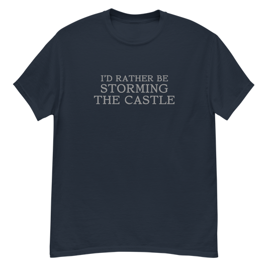 "I'd rather be storming the castle" printed on a navy unisex classic tee laying on a flat surface