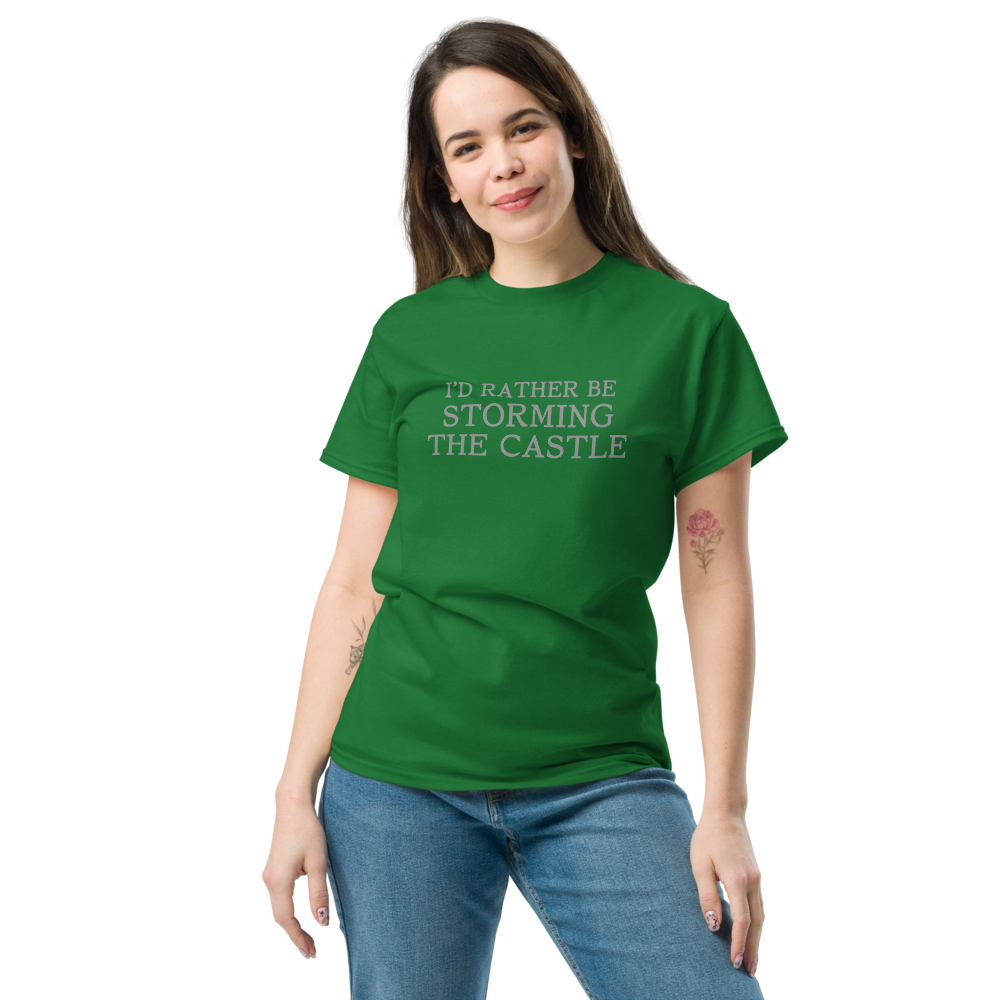 "I'd rather be storming the castle" printed on a turf green unisex classic tee worn by a female