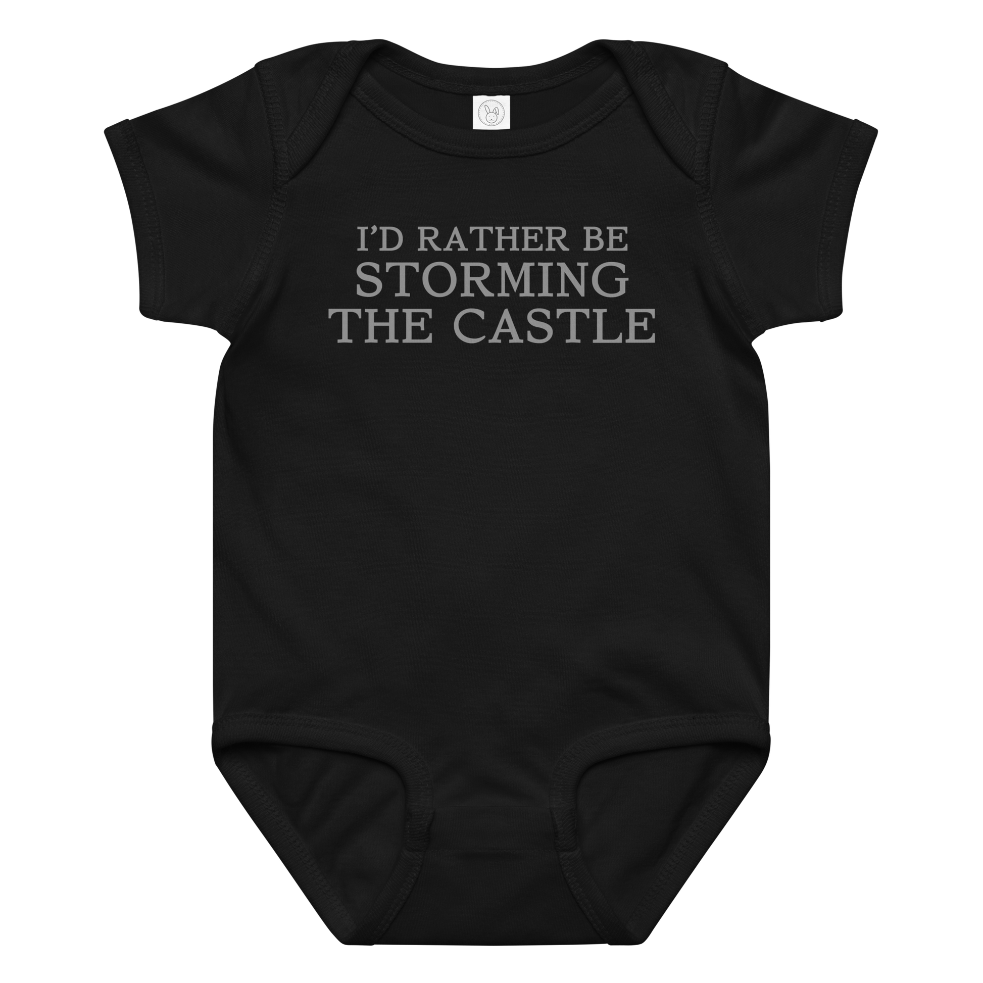 "I'd rather be storming the castle" printed on a black baby jersey bodysuit laying on a flat surface amongst other clothes