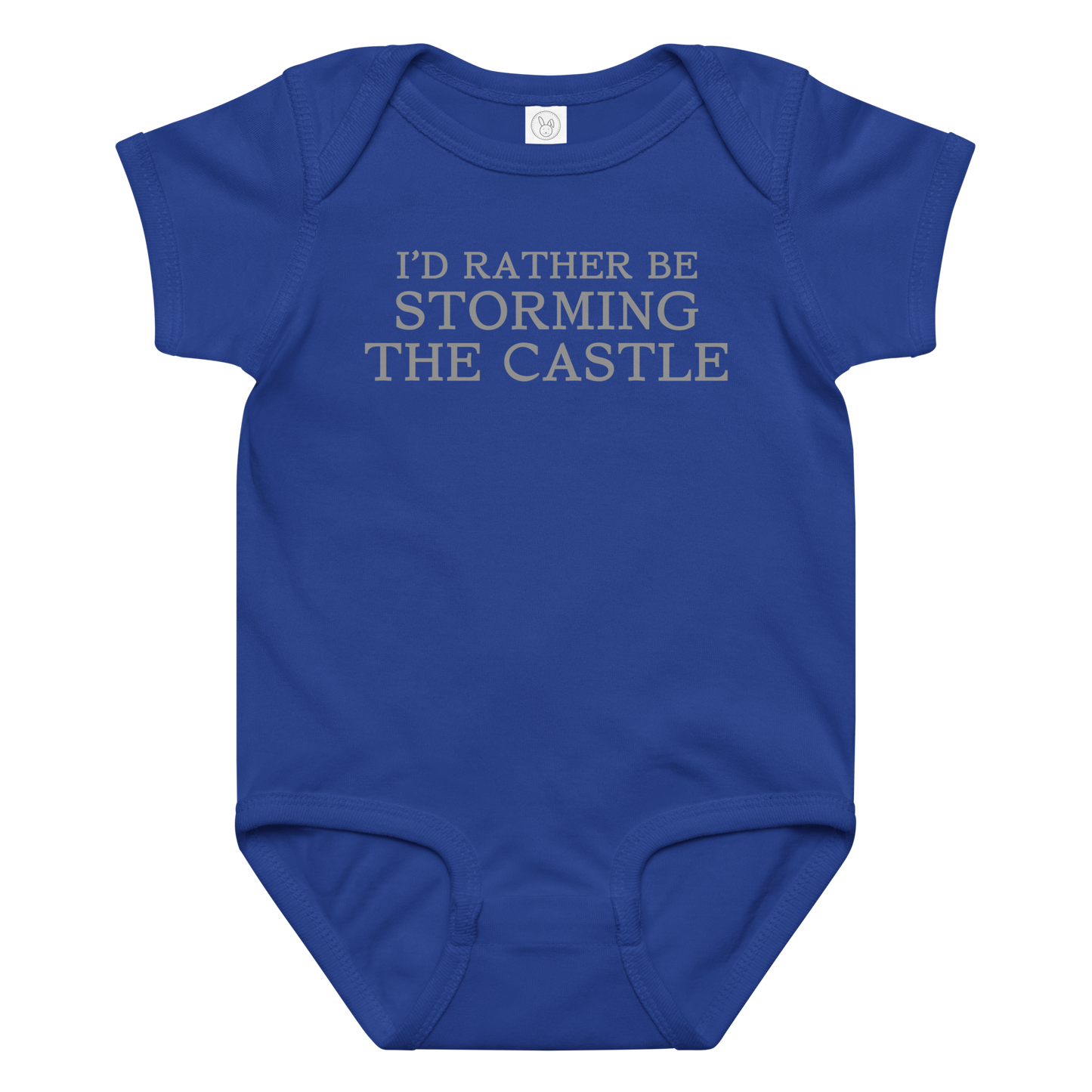 "I'd rather be storming the castle" printed on a royal baby jersey bodysuit laying on a flat surface amongst other clothes
