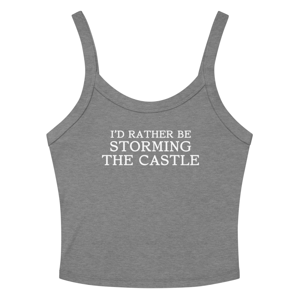 "I'd rather be storming the castle" printed on a athletic heather women's micro-rib tanktop laying on a flat surface amongst sunglasses and shorts