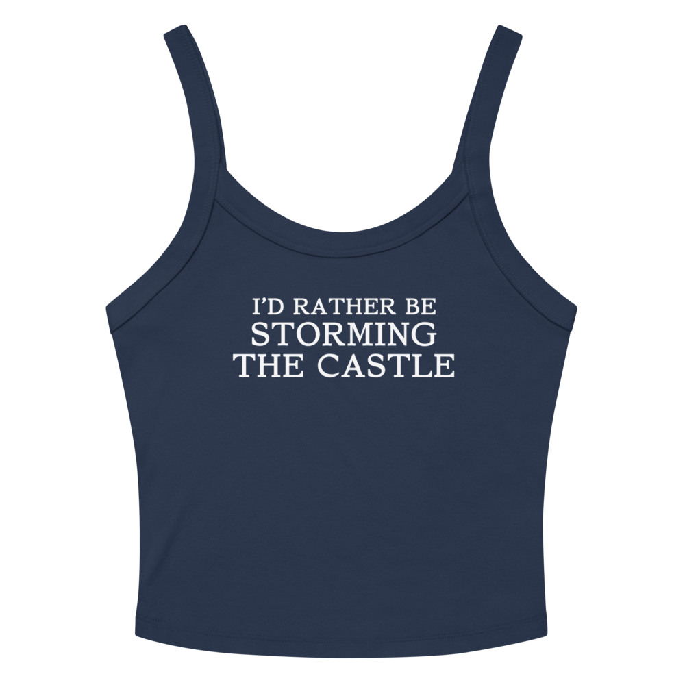 "I'd rather be storming the castle" printed on a solid navy blend women's micro-rib tanktop laying on a flat surface amongst sunglasses and shorts