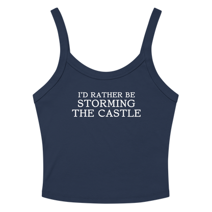 "I'd rather be storming the castle" printed on a solid navy blend women's micro-rib tanktop laying on a flat surface amongst sunglasses and shorts