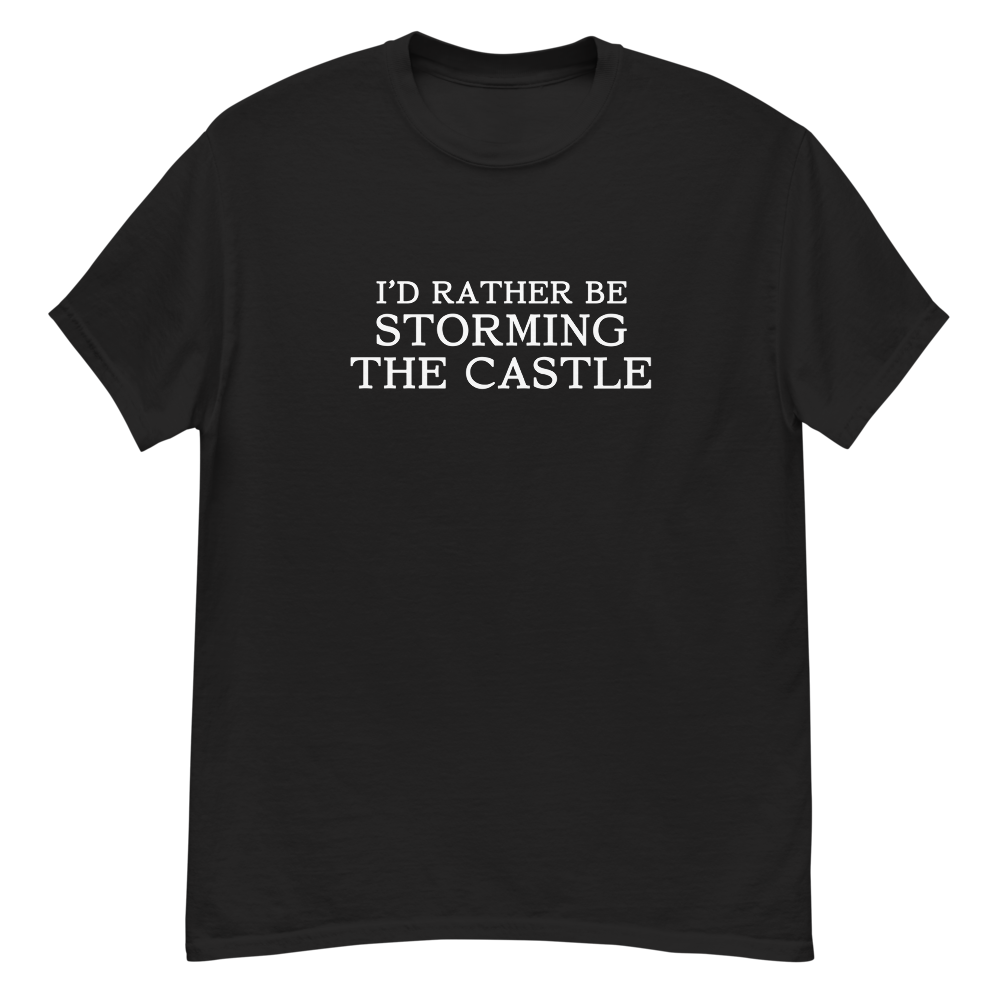 "I'd rather be storming the castle" printed on a black unisex classic tee laying on a flat surface