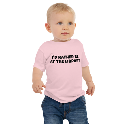 "I’d rather be at the library" printed on a pink baby jersey short sleeve tee worn by a male