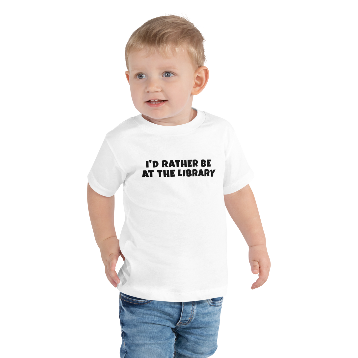 "I’d rather be at the library" printed on a white toddler short sleeve tee worn by a male