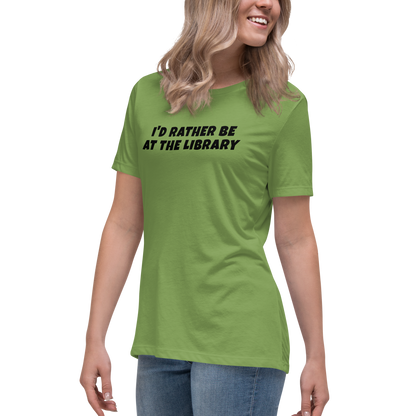 "I’d rather be at the library" printed on a leaf women's relaxed t-shirt worn by a female