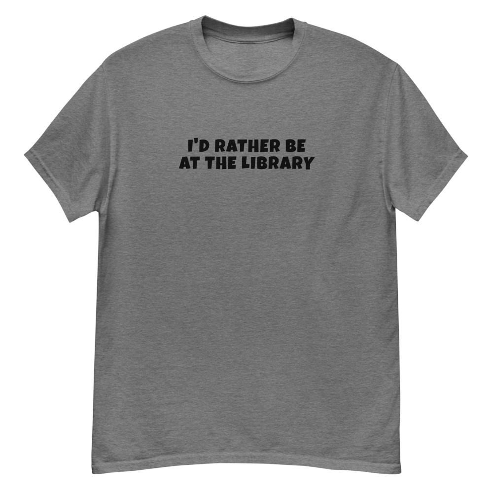 "I’d rather be at the library" printed on a graphite heather unisex classic tee laying on a flat surface
