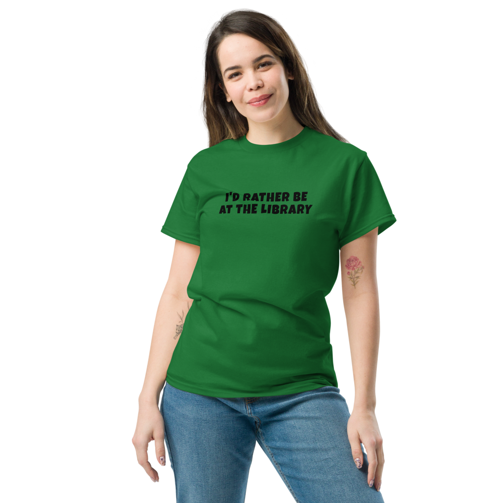 "I’d rather be at the library" printed on a turf green unisex classic tee worn by a female
