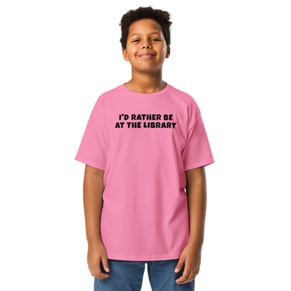 "I’d rather be at the library" printed on a azalea youth classic tee worn by a male