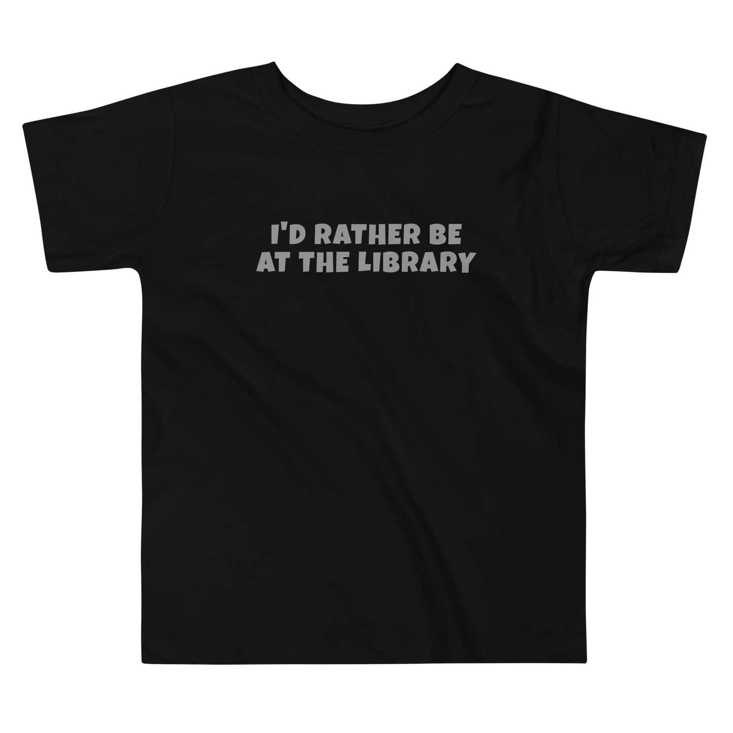 "I’d rather be at the library" printed on a black toddler short sleeve tee laying on a flat surface