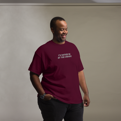 "I’d rather be at the library" printed on a maroon unisex classic tee worn by a male
