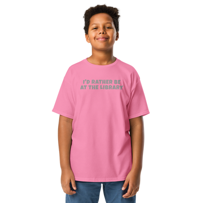 "I’d rather be at the library" printed on a azalea youth classic tee worn by a male