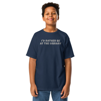 "I’d rather be at the library" printed on a navy youth classic tee worn by a male