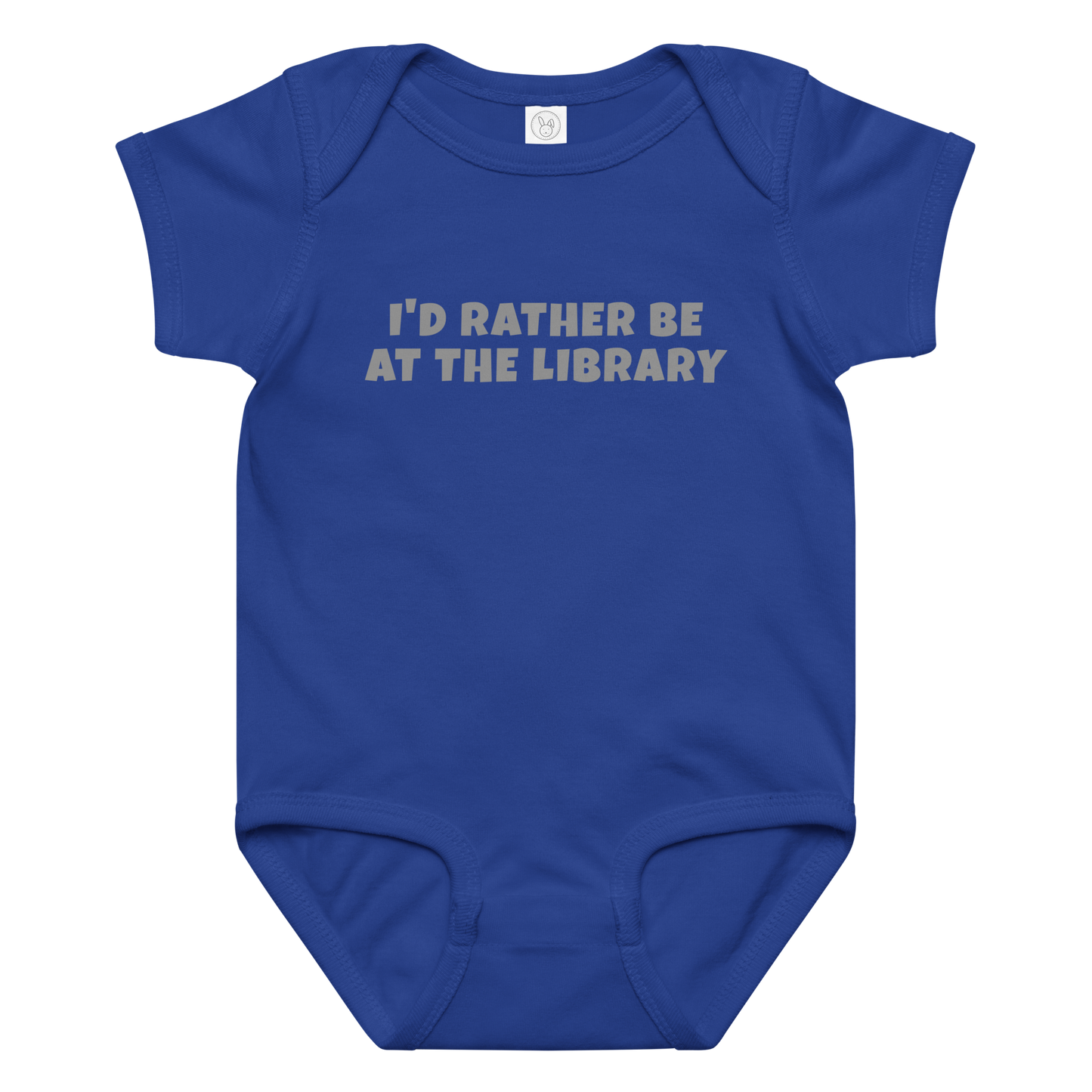 "I’d rather be at the library" printed on a royal baby jersey bodysuit laying on a flat surface amongst other clothes