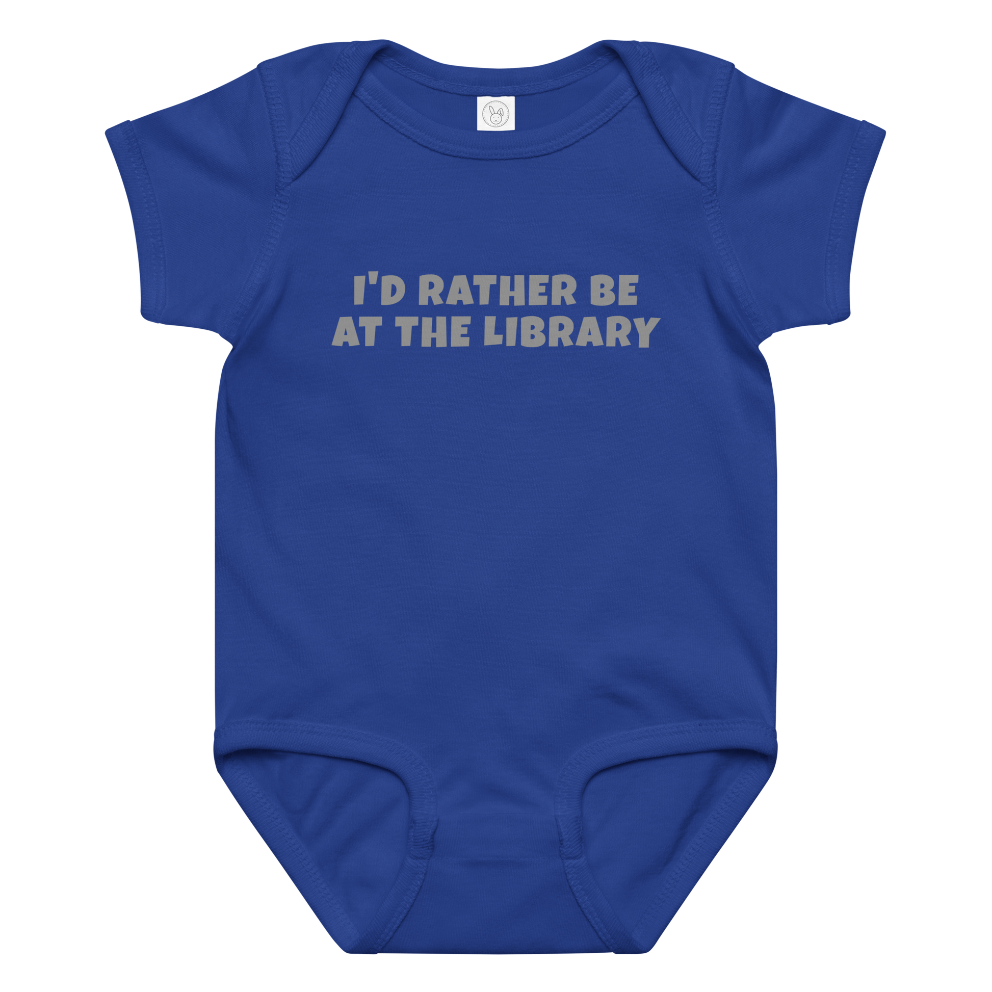"I’d rather be at the library" printed on a royal baby jersey bodysuit laying on a flat surface amongst other clothes