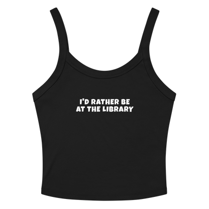 "I’d rather be at the library" printed on a solid black blend women's micro-rib tanktop laying on a flat surface amongst sunglasses and shorts