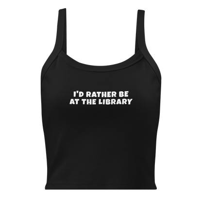 "I’d rather be at the library" printed on a solid black blend women's micro-rib tanktop laying on a flat surface