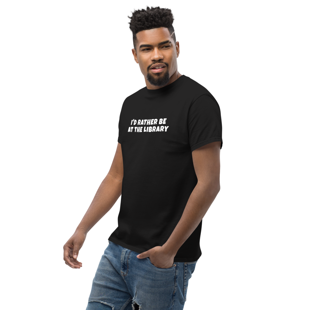 "I’d rather be at the library" printed on a black unisex classic tee worn by a male