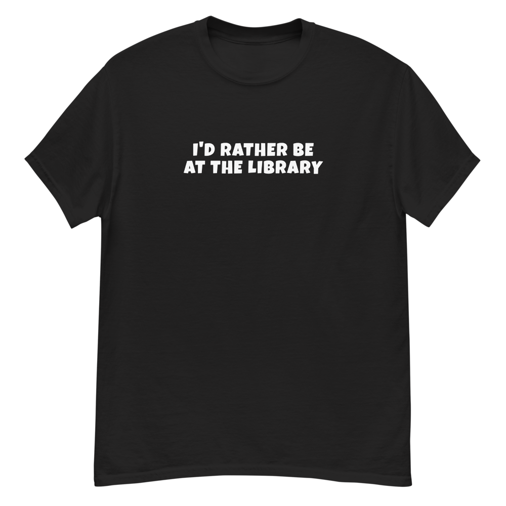 "I’d rather be at the library" printed on a black unisex classic tee laying on a flat surface