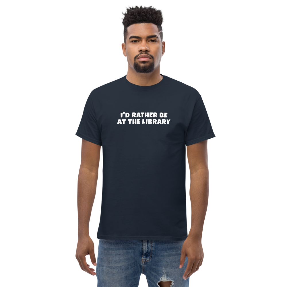 "I’d rather be at the library" printed on a navy unisex classic tee worn by a male