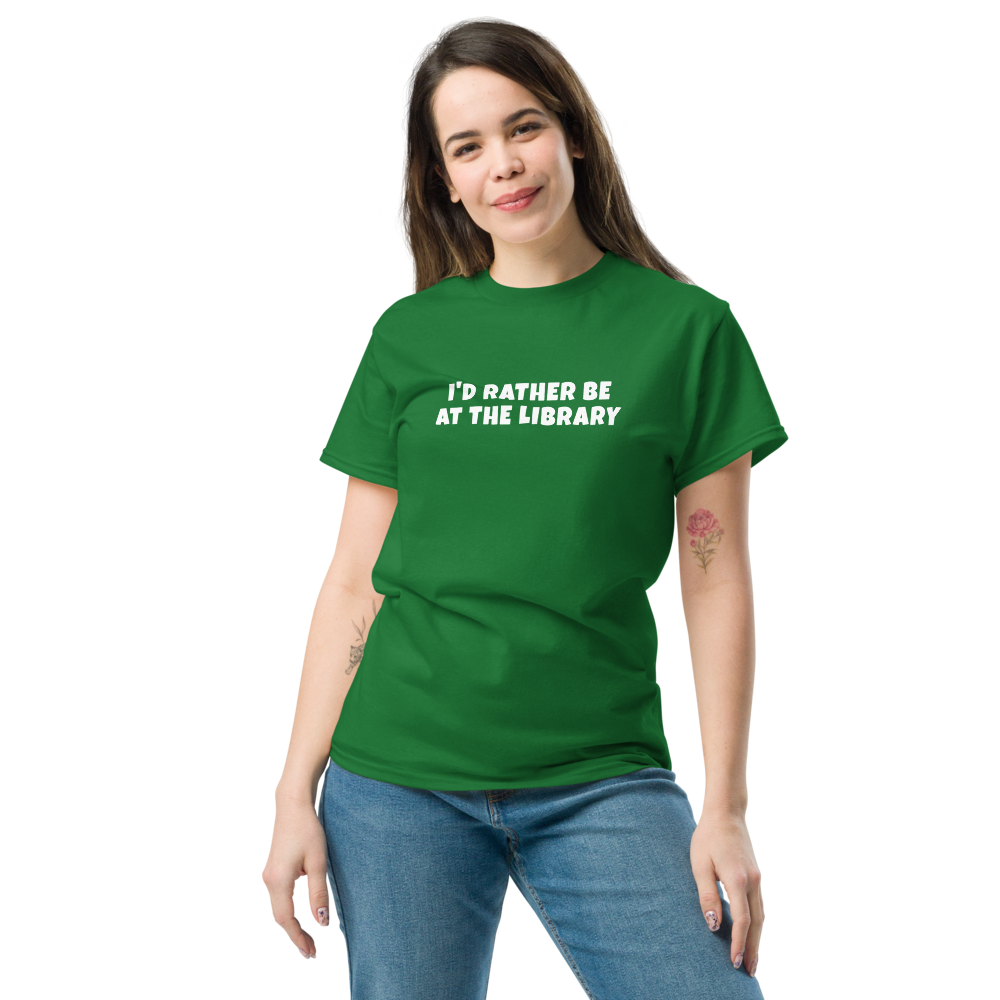 "I’d rather be at the library" printed on a turf green unisex classic tee worn by a female