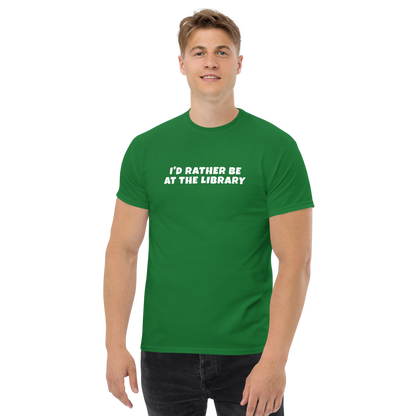 "I’d rather be at the library" printed on a turf green unisex classic tee worn by a male
