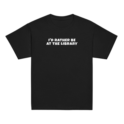 "I’d rather be at the library" printed on a black youth classic tee laying on a flat surface