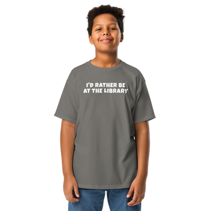 "I’d rather be at the library" printed on a charcoal youth classic tee worn by a male