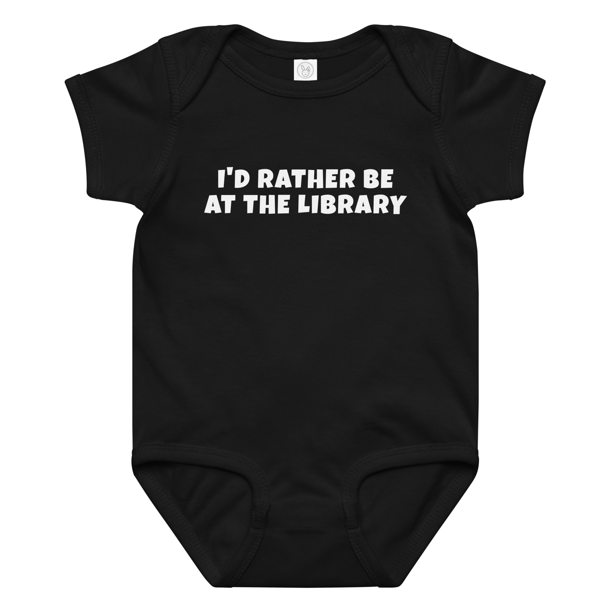 "I’d rather be at the library" printed on a black baby jersey bodysuit laying on a flat surface amongst other clothes