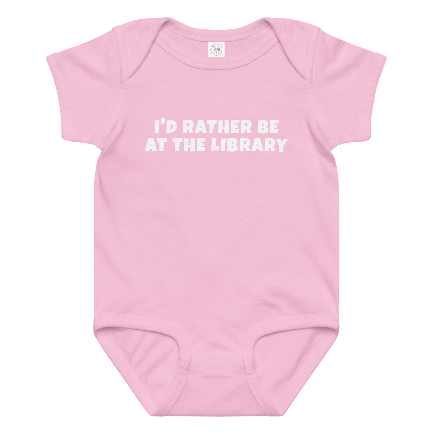 "I’d rather be at the library" printed on a pink baby jersey bodysuit laying on a flat surface amongst other clothes